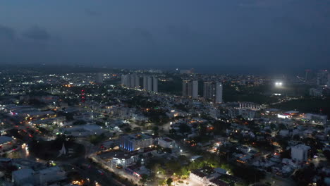 Imágenes-Panorámicas-Aéreas-Del-Barrio-Urbano-Por-La-Noche.-Edificios-Altos-Y-Modernos-En-Un-Complejo-De-Apartamentos-En-Segundo-Plano.-Cancún-México