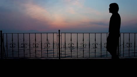 sadness alone man silhouette walking with seaview