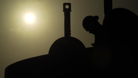 man at sunset on oil rig