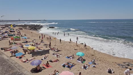 people enjoy a sunny day on porto's ingleses beach, relaxing and swimming by the ocean