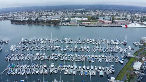 huge marina full of sailboats and equipment on a sunny cloudy day