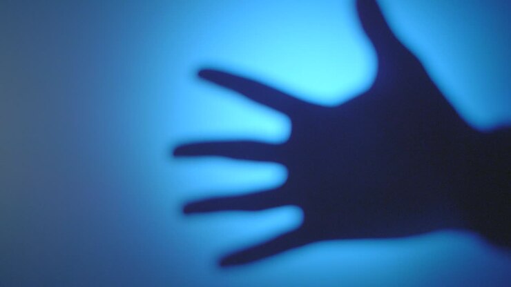 Mysterious Hand Silhouettes in Blue Light