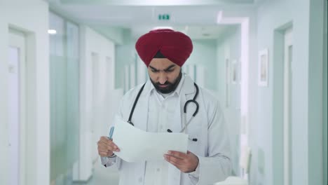 serious sikh indian doctor checking medical reports