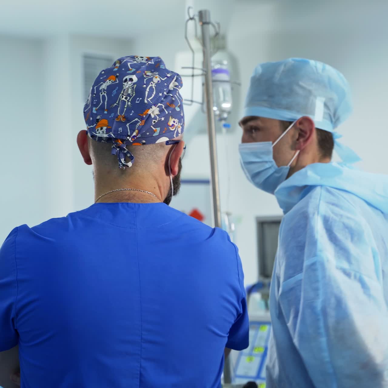 Anesthesiologist and surgeon stand over the prepared patient before surgery. Specialists talking and discussing the procedure