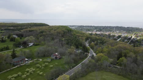 aerial backwards flight showing grimsby, a small city located near lake ontario in canada