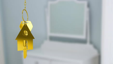 golden house keychain animation over blurred white furniture background