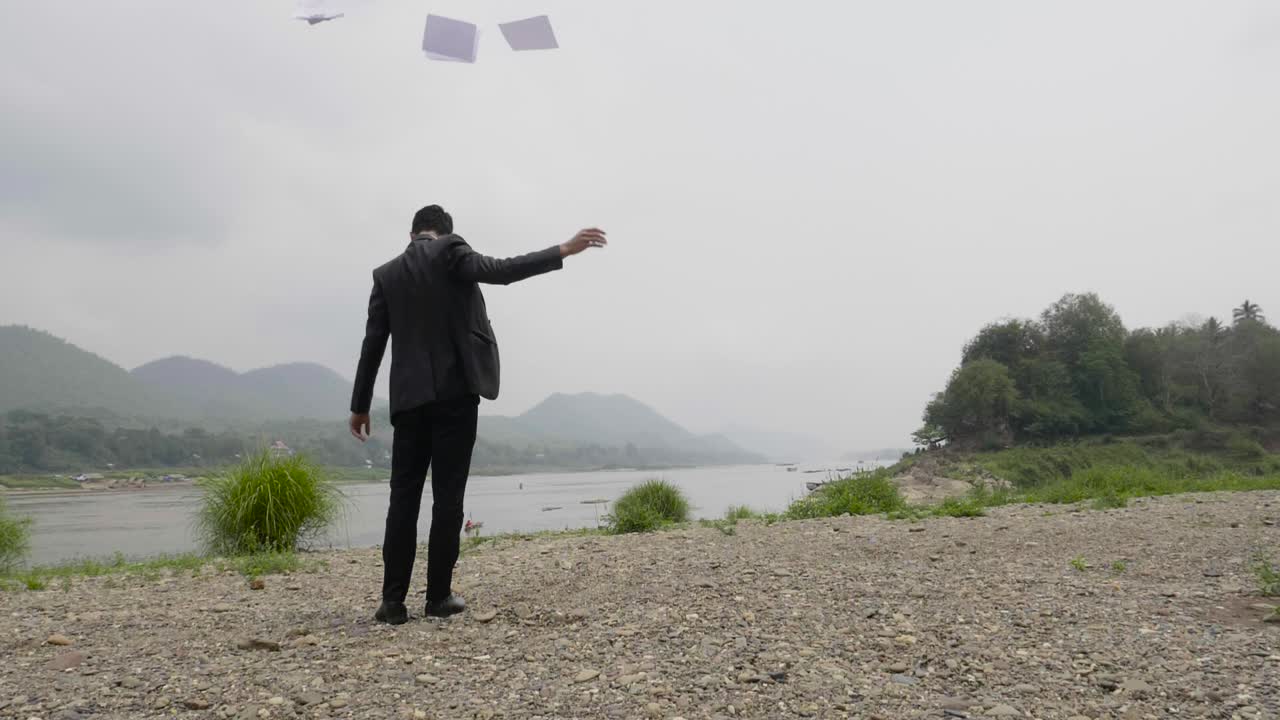 Businessman with Papers Flying Away