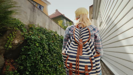 Tourist-With-A-Map-In-Her-Hands-Walking-Through-The-Narrow-Streets-Of-Bergen-In-Norway-Holidays-In-S