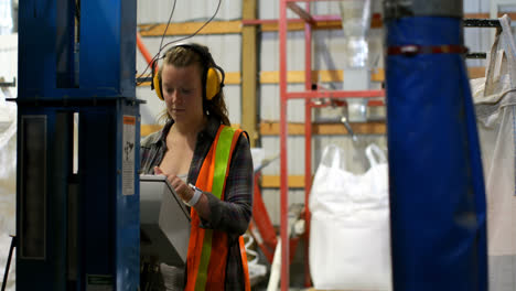 Front-view-of-young-caucasian-female-worker-working-in-factory-4k