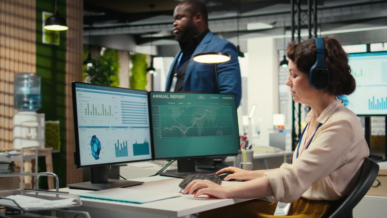 Vertical Video Female executive consultant listening to songs on headphones at the workstation