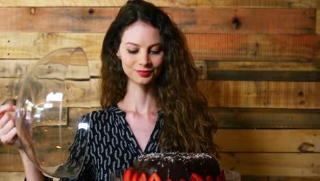 Portrait-of-female-customer-holding-cake