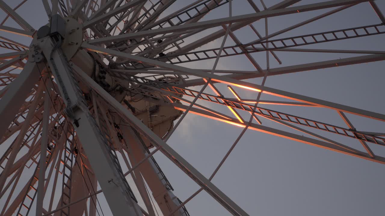 Ferris wheel glows above Opal Coast at dusk Low angle