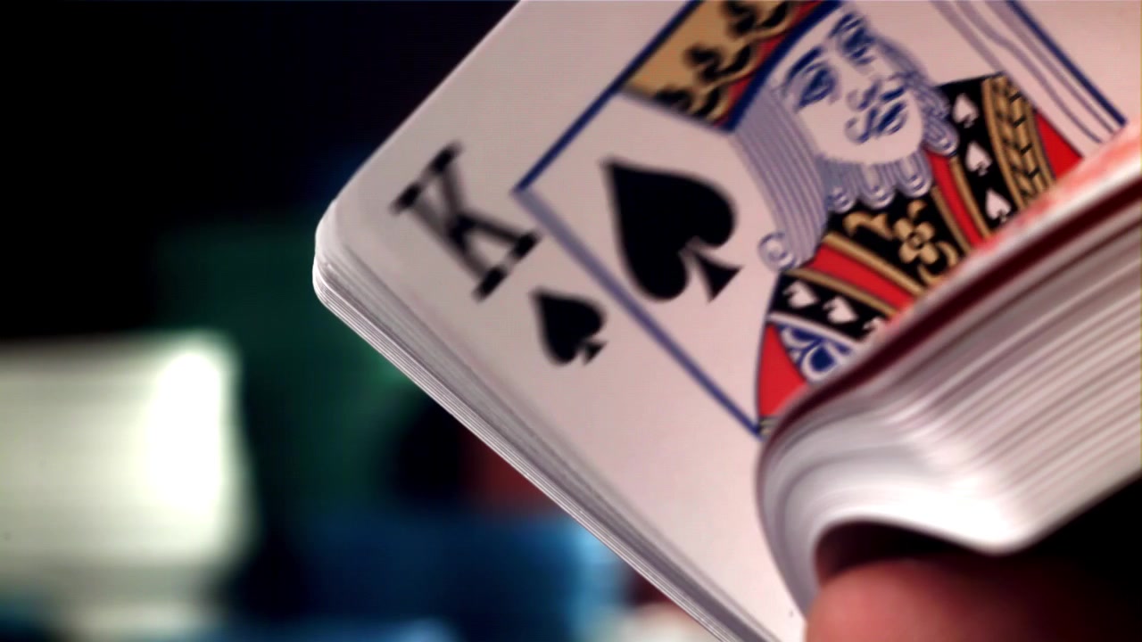 Close-up of a Hand Fanning Through a Deck of Playing Cards