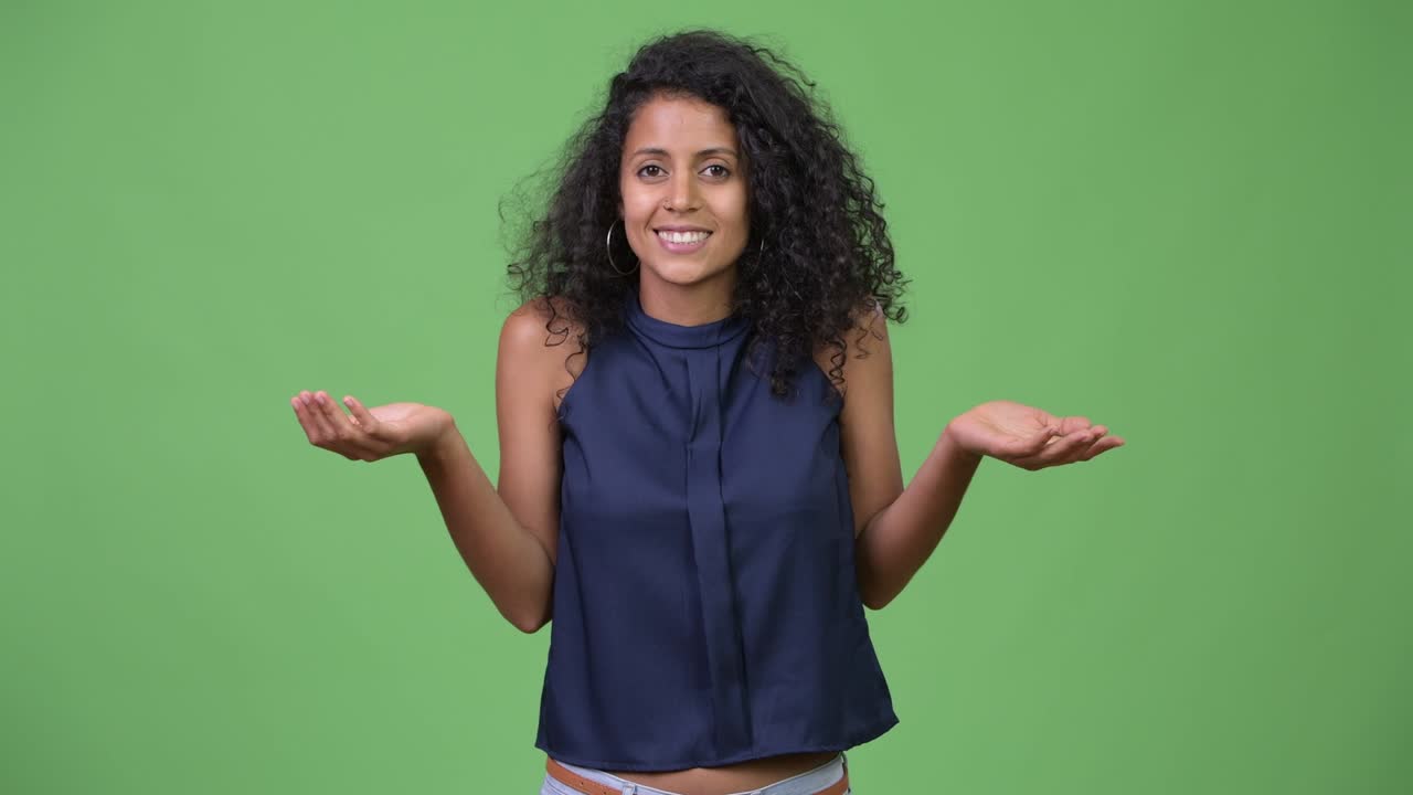 Young beautiful Hispanic businesswoman shrugging shoulders