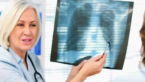 Female-doctor-discussing-x-ray-report-with-a-patient