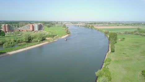 aerial view of the canal or lake in holland with a boat crossing on it