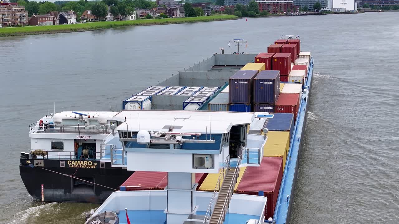 Barge carrying shipping containers on a river