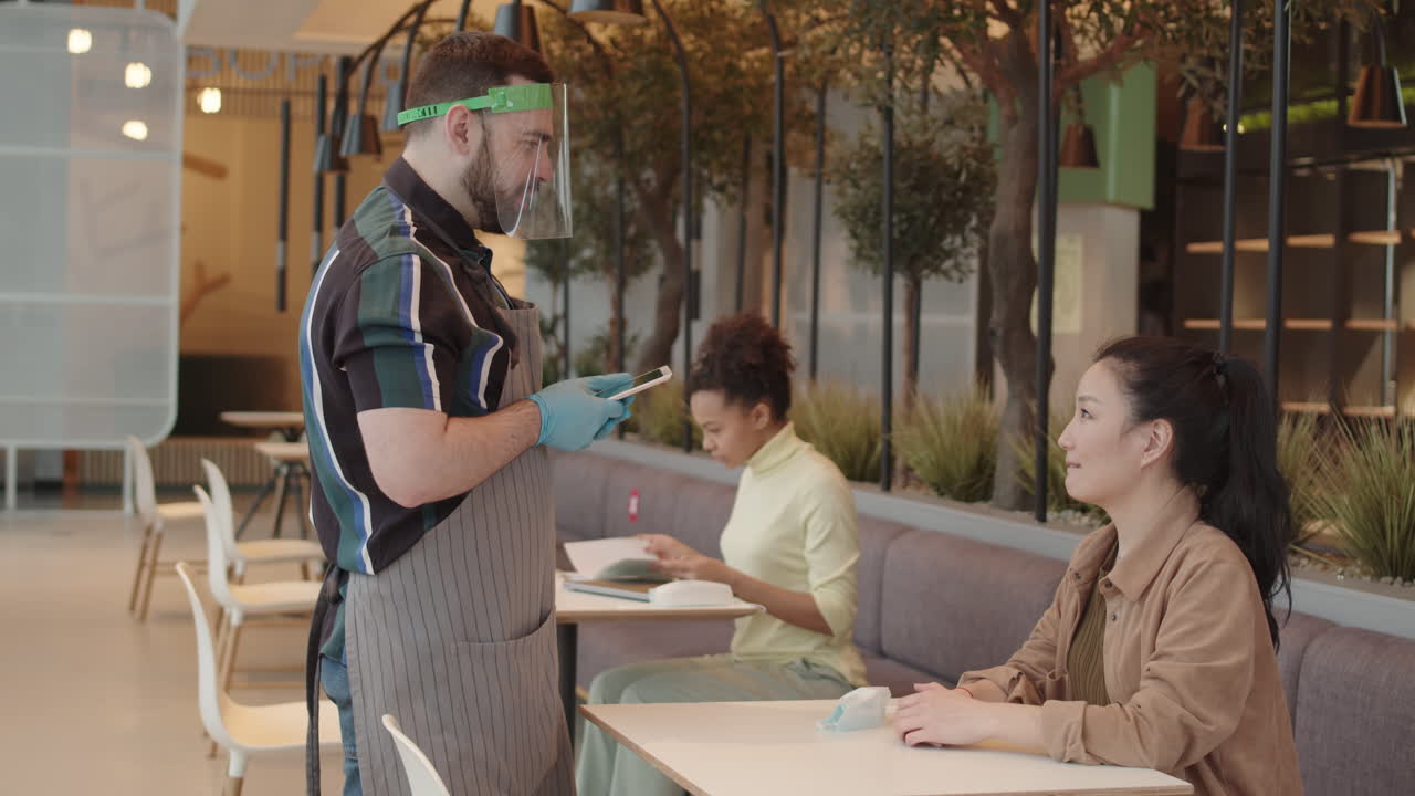 Waiter Taking Order from Asian Woman