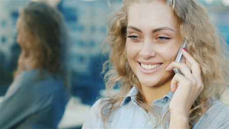 portrait of attractive woman talking on the phone smiling the wind blowing in her hair