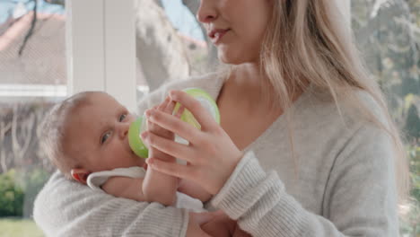 mother feeding baby drinking from milk bottle loving mom caring for infant at home motherhood responsibility 4k