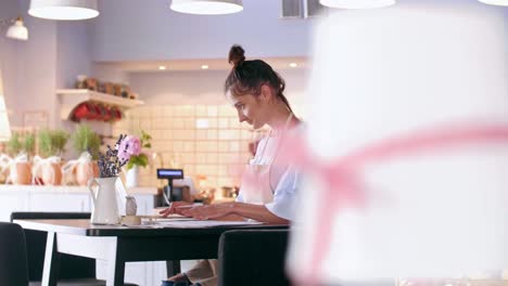 barista using a laptop at work