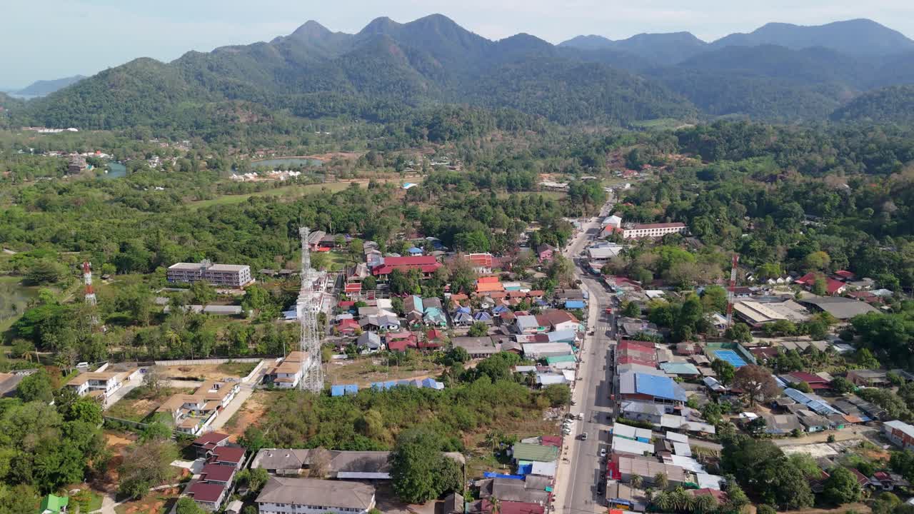 A birds-eye view of Klong Prao village on a sunny morning, roads, buildings, and resorts with light traffic in this tropical destination