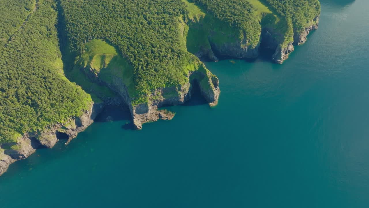 Aerial Drone fly above Shiretoko forested mountain cliffs, pristine wilderness of Hokkaido Japan, National Park