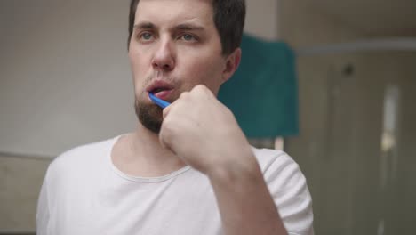 man brushing his teeth