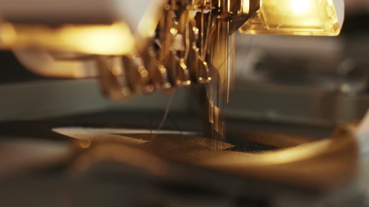 The automatic embroidery machine is working at high speed. Close-up