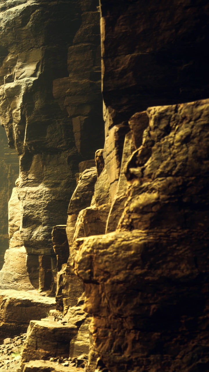 View of rocky cliffs at sunset with shadows and warm light on the surface