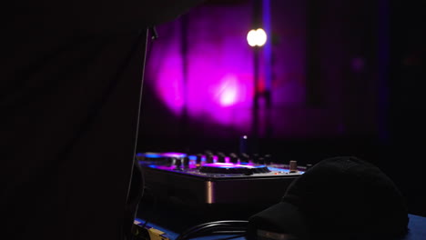 man with black sweatshirt djing at the disco