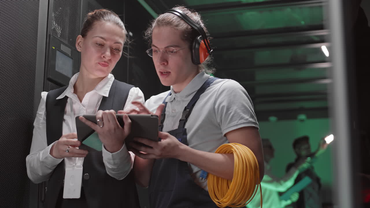 Technicians in Data Center Using Tablet