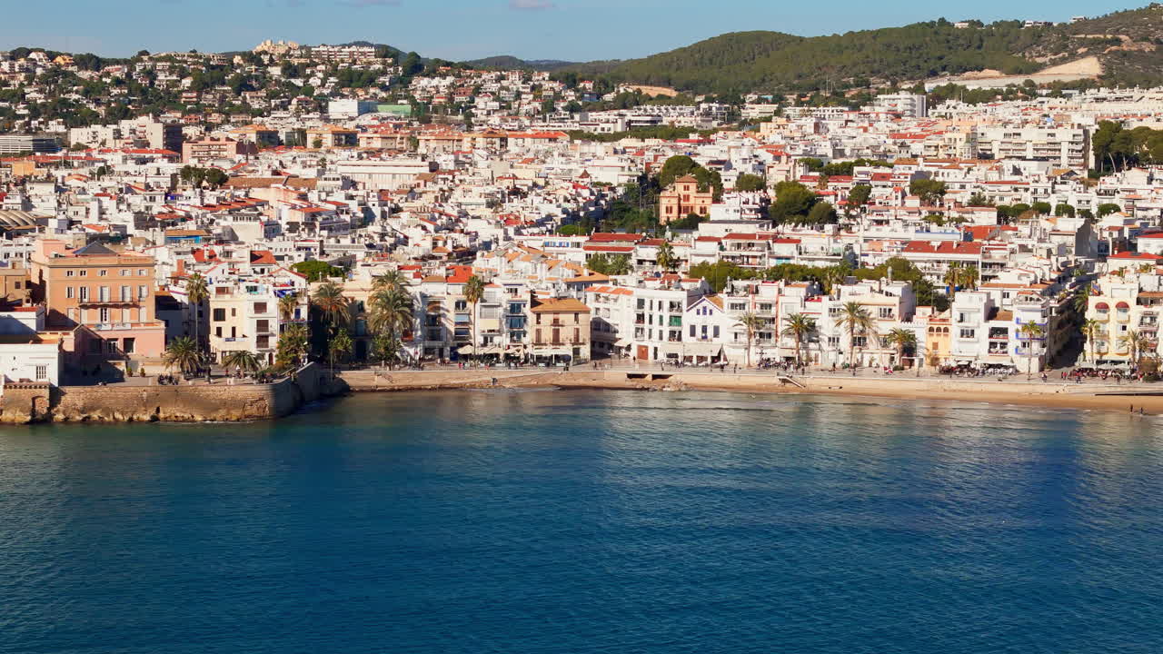 Drone captures charming old sailors' town in sunny weather with a beautiful blue sea coast backdrop