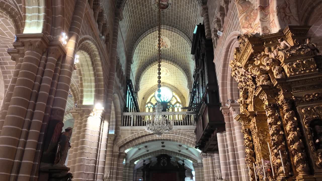 Gilded altar and arched ceiling inside historic cathedral interior, Évora Portugal