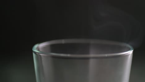 Macro-of-a-thin-stream-of-smoke-over-the-glass