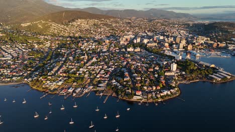 boats moored along shores of derwent river at hobart city,tasmania in australia