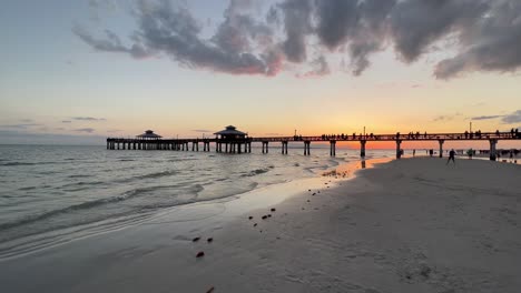 silhouette of pier during a beautiful sunset at fort myers beach, florida