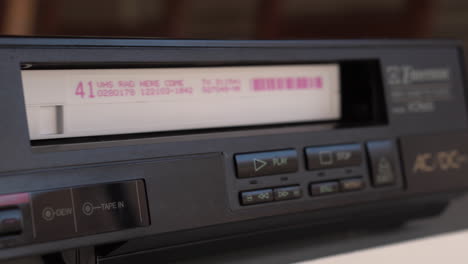 Stopping-Playback-and-Ejecting-Video-Cassette-Tape-From-Vintage-Player,-Close-Up