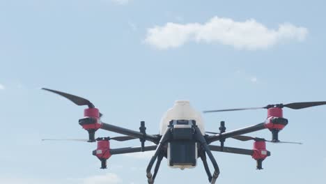 professional drone with camera flying in the blue sky