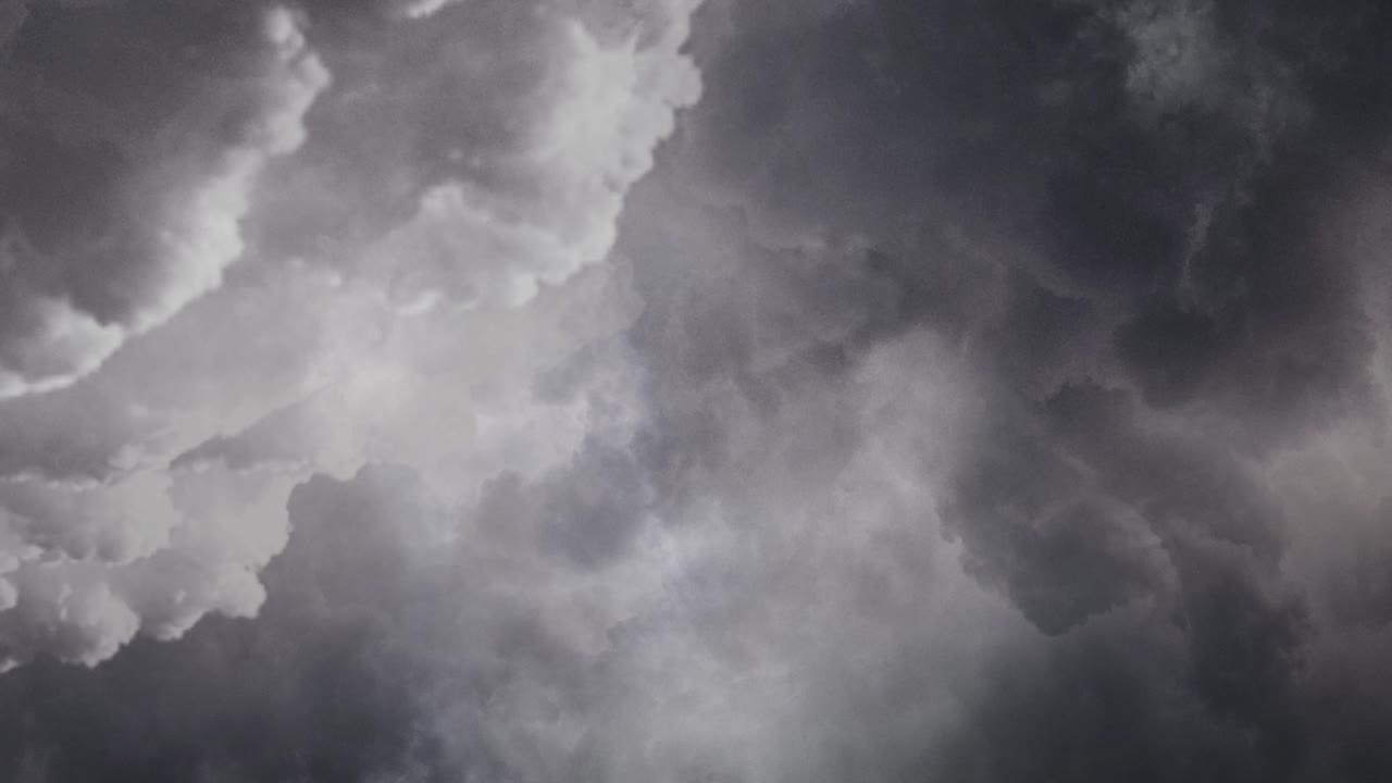 Dark clouds moving in the sky with lightning flashes 4k