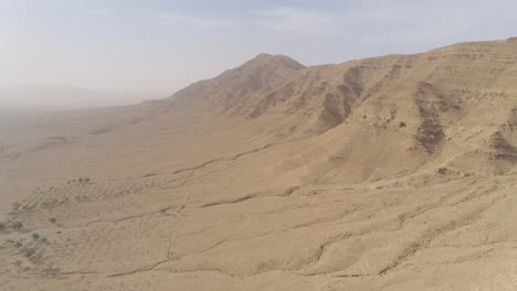 isolated rocky mountain surrounded by sand and dry plains in tunisia