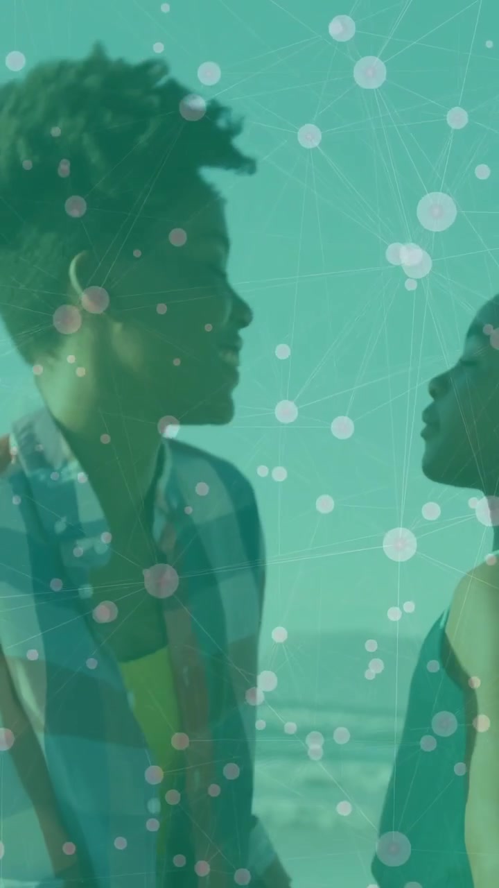 Vertical video: Mom holding kid on beach, kid reaching as mom hugging with teal overlay for family