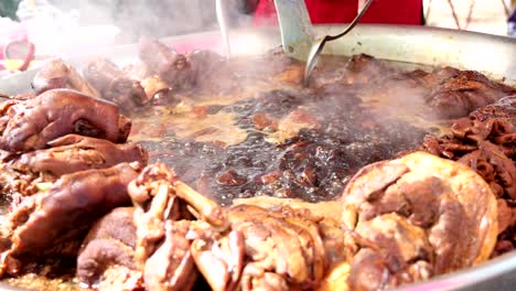 cooking pork leg stew in a large pot.