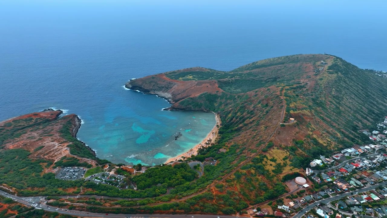 Avvicinamento alla splendida Hanauma Bay a Honolulu, Hawaii, USA. Scenario mozzafiato della costa pittoresca con un paesaggio marino blu che si fonde con il cielo. Vista aerea
