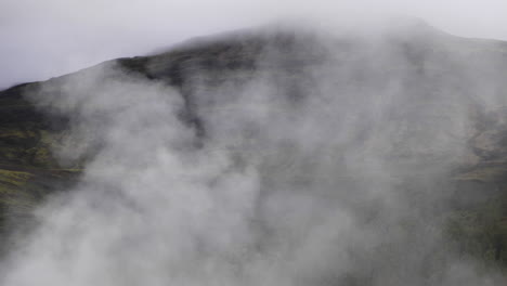 Hot spring steam releasing into the mountains of Iceland