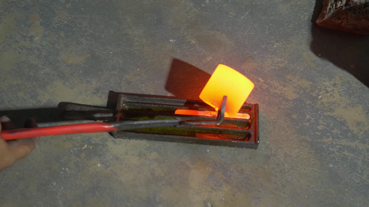 Melting gold, molted gold pouring into bar