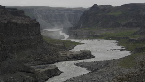 the harsh terrain and powerful river jokulsa a fjollum below dettifoss falls - icelands barren and forebodinglandscape