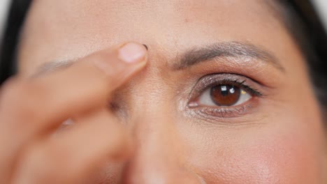 close up of indian mother putting bindi