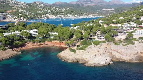 Cala-Marmassen-Cove-at-Port-Andratx-in-Mallorca-Spain-with-resorts-and-homes-by-the-beach,-Aerial-dolly-out-reveal-shot