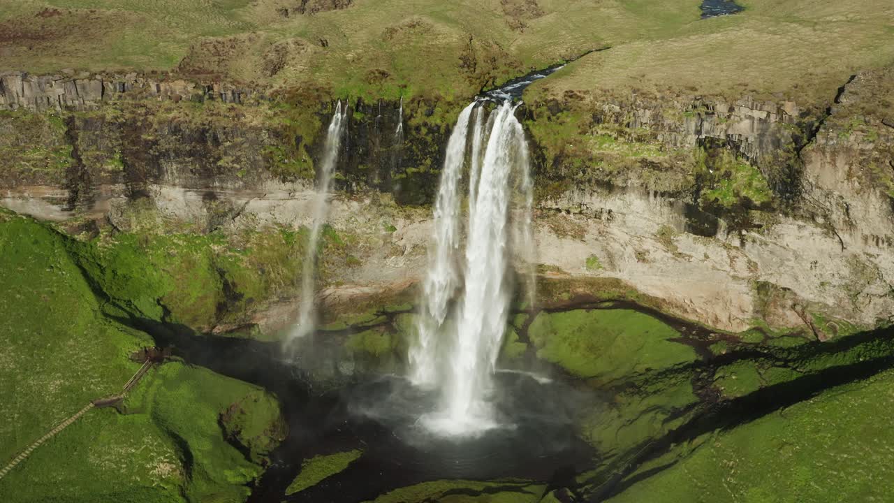 Grand Seljalandsfoss waterfall in scenic highlands of Iceland with birds